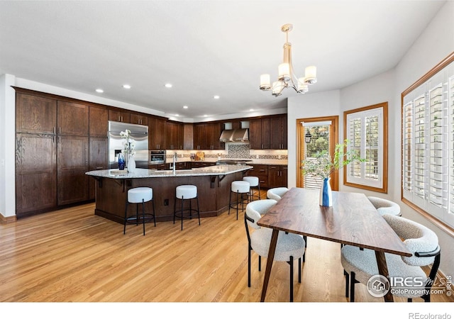 14601 Akron St, Brighton, CO 80602 - dining space featuring light wood-style flooring, plenty of natural light, a chandelier, and recessed lighting