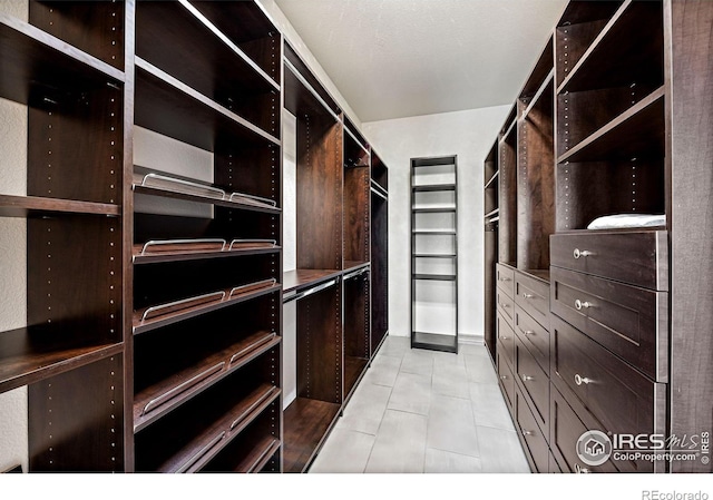14601 Akron St, Brighton, CO 80602 - walk in closet featuring light tile patterned floors