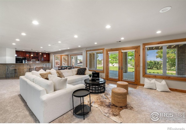 14601 Akron St, Brighton, CO 80602 - living room featuring recessed lighting, plenty of natural light, and light colored carpet