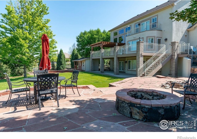 14601 Akron St, Brighton, CO 80602 - view of patio featuring an outdoor fire pit, stairway, and outdoor dining area