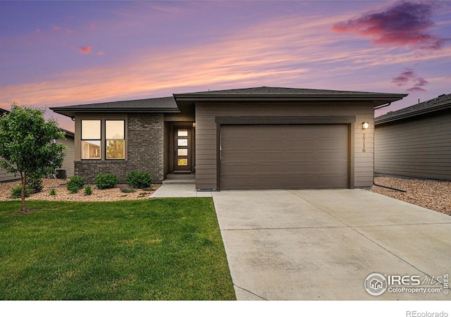 2716 San Cristobal Ct, Timnath, CO 80547 - prairie-style home with concrete driveway, a garage, and a front lawn