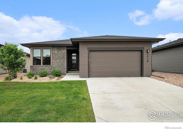2716 San Cristobal Ct, Timnath, CO 80547 - prairie-style home featuring driveway, an attached garage, and a front lawn