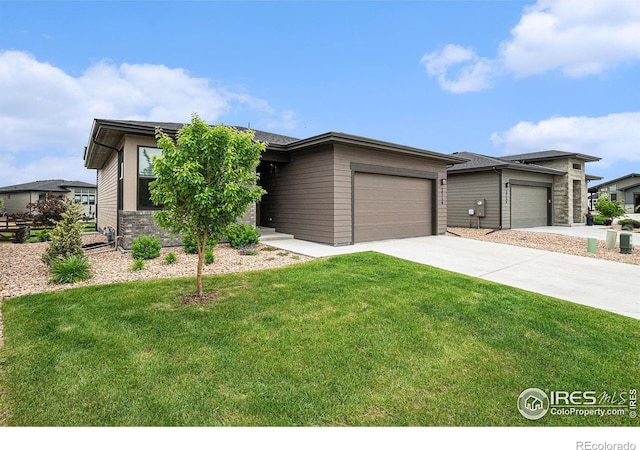 2716 San Cristobal Ct, Timnath, CO 80547 - prairie-style house featuring an attached garage, a front lawn, and driveway