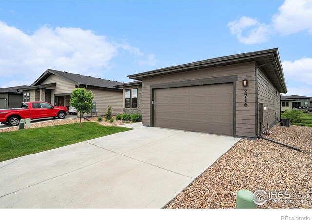 2716 San Cristobal Ct, Timnath, CO 80547 - ranch-style home with concrete driveway, a garage, and a front yard