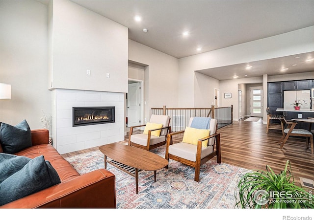 2716 San Cristobal Ct, Timnath, CO 80547 - living room featuring wood finished floors, recessed lighting, and a tile fireplace