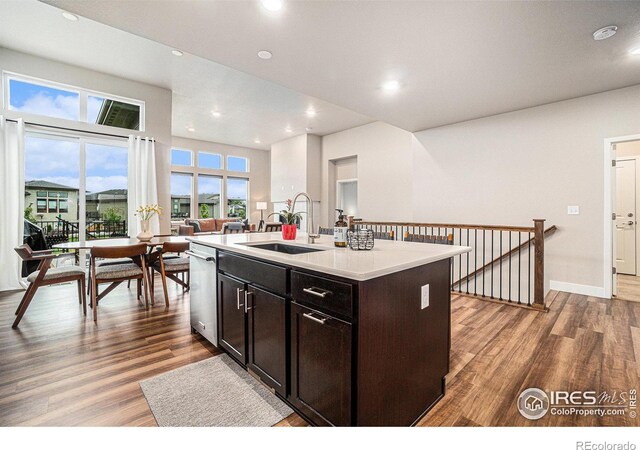 2716 San Cristobal Ct, Timnath, CO 80547 - kitchen with wood finished floors, stainless steel dishwasher, light countertops, recessed lighting, and a center island with sink