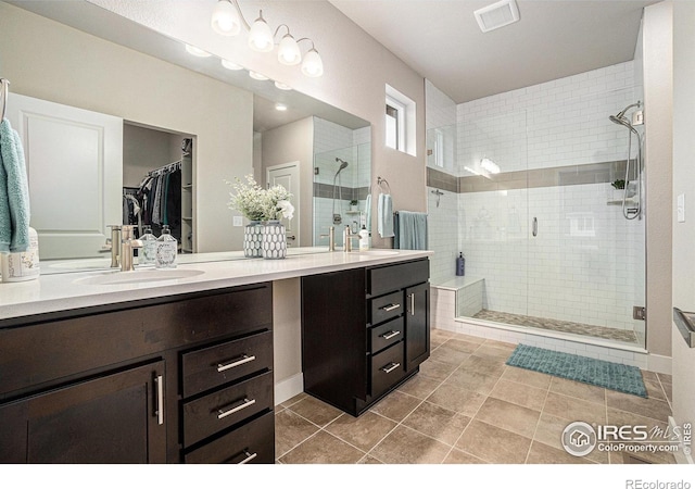 2716 San Cristobal Ct, Timnath, CO 80547 - full bathroom featuring double vanity, a shower stall, a walk in closet, and tile patterned floors