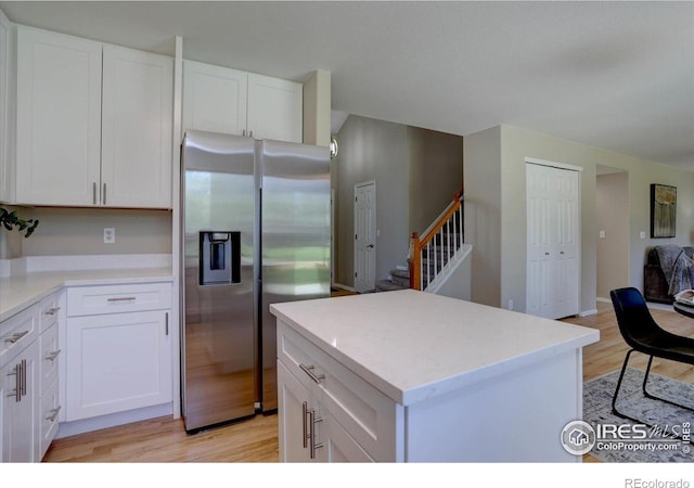 13382 Franklin St, Thornton, CO 80241 - kitchen with stainless steel fridge with ice dispenser, light wood-type flooring, and white cabinetry