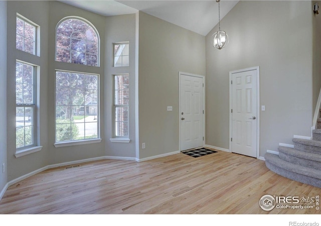 13382 Franklin St, Thornton, CO 80241 - foyer entrance with high vaulted ceiling, wood finished floors, and stairway