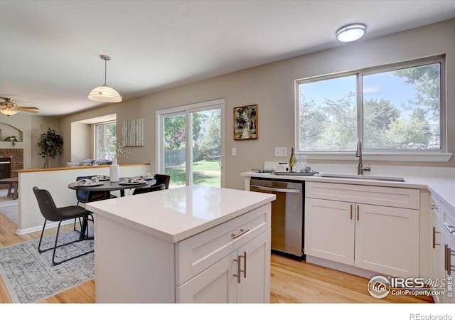 13382 Franklin St, Thornton, CO 80241 - kitchen with dishwasher, light wood-style floors, white cabinetry, and light countertops