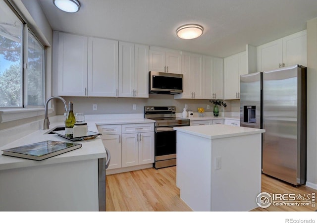 13382 Franklin St, Thornton, CO 80241 - kitchen featuring stainless steel appliances, light wood-style flooring, and white cabinets