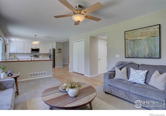 13382 Franklin St, Thornton, CO 80241 - living room with a ceiling fan and light colored carpet