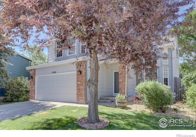 13382 Franklin St, Thornton, CO 80241 - view of property hidden behind natural elements featuring an attached garage, concrete driveway, and brick siding