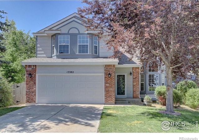 13382 Franklin St, Thornton, CO 80241 - traditional-style house with driveway, brick siding, an attached garage, a front lawn, and a shingled roof