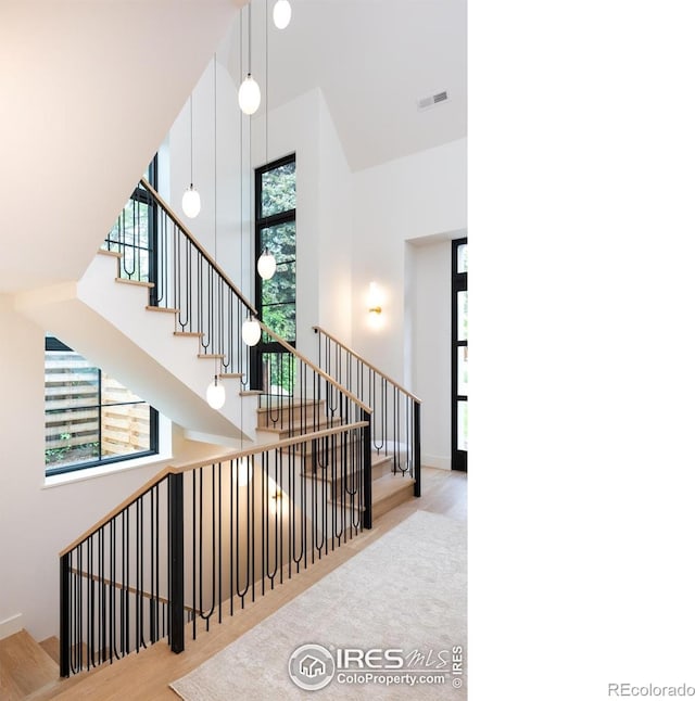 640 Iris Ave, Boulder, CO 80304 - staircase featuring wood finished floors and a towering ceiling