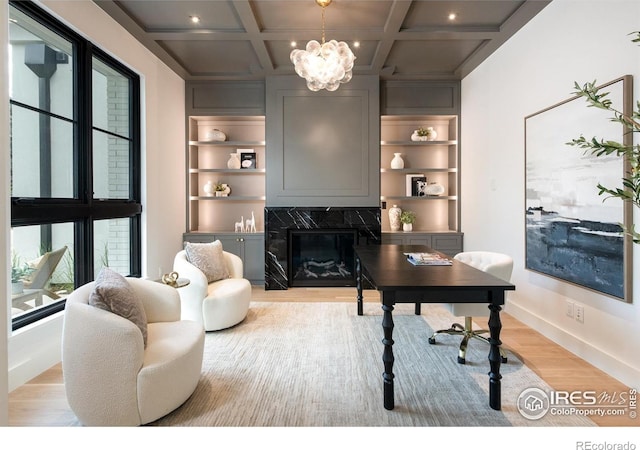 640 Iris Ave, Boulder, CO 80304 - office space featuring light wood-style floors, a chandelier, a premium fireplace, beam ceiling, and built in shelves