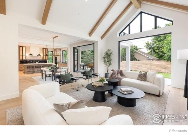 640 Iris Ave, Boulder, CO 80304 - living room with light wood finished floors, beam ceiling, healthy amount of natural light, and high vaulted ceiling