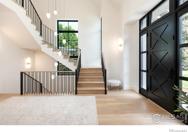 640 Iris Ave, Boulder, CO 80304 - foyer with a towering ceiling, wood finished floors, and stairs