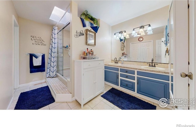 4557 W Pioneer Ln, Greeley, CO 80634 - bathroom with tile patterned floors, a shower stall, a skylight, and double vanity