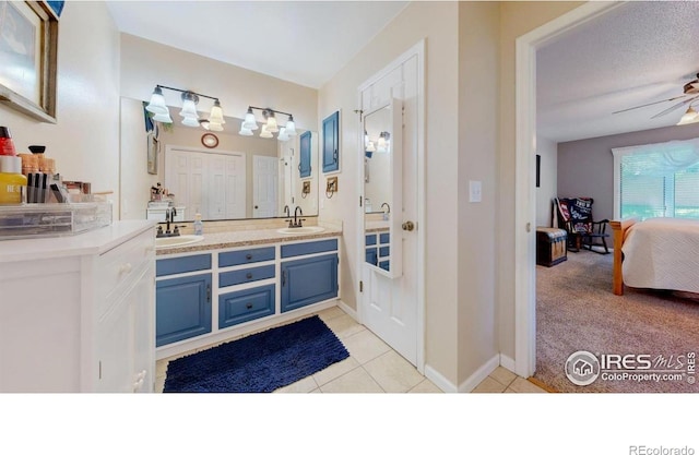 4557 W Pioneer Ln, Greeley, CO 80634 - full bathroom with double vanity, connected bathroom, a ceiling fan, and tile patterned flooring