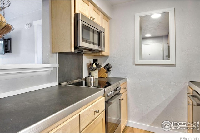2636 Juniper Ave Unit 1, Boulder, CO 80304 - kitchen with stainless steel appliances, light brown cabinetry, and dark countertops