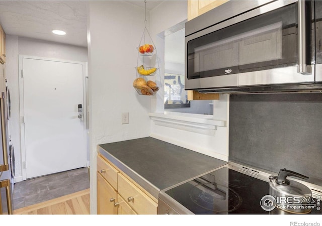 2636 Juniper Ave Unit 1, Boulder, CO 80304 - kitchen with stainless steel microwave, light brown cabinets, dark countertops, stove, and recessed lighting