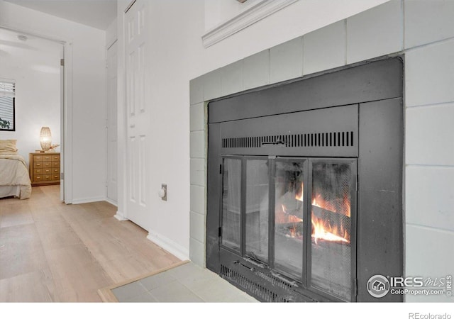 910 Portland Pl Unit 7, Boulder, CO 80304 - detailed view of a lit fireplace and wood finished floors
