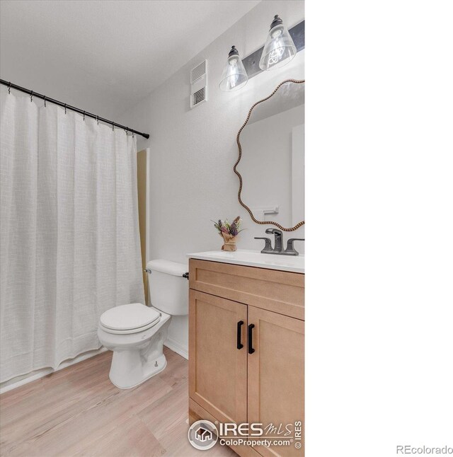 910 Portland Pl Unit 7, Boulder, CO 80304 - bathroom featuring vanity, wood finished floors, and a shower with shower curtain