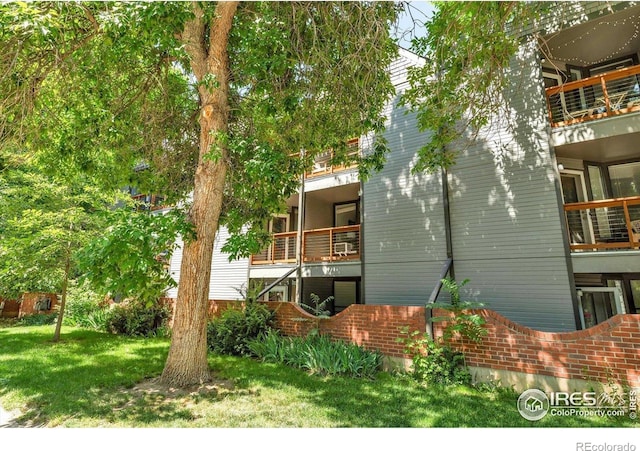 910 Portland Pl Unit 7, Boulder, CO 80304 - view of home's exterior with a balcony and a lawn