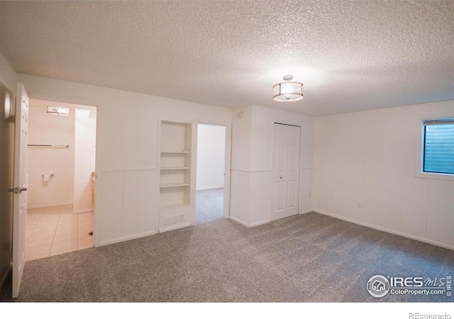 3025 Regatta Ln Unit 3, Fort Collins, CO 80525 - unfurnished room with carpet flooring, a textured ceiling, and built in features