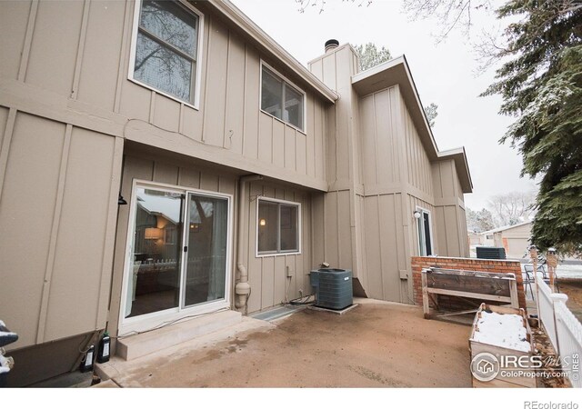 3025 Regatta Ln Unit 3, Fort Collins, CO 80525 - rear view of house with board and batten siding, a patio area, and a chimney
