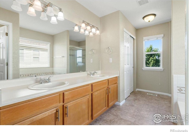 17216 E Trailmaster Dr, Parker, CO 80134 - bathroom with double vanity, a shower stall, tile patterned floors, and a bathtub