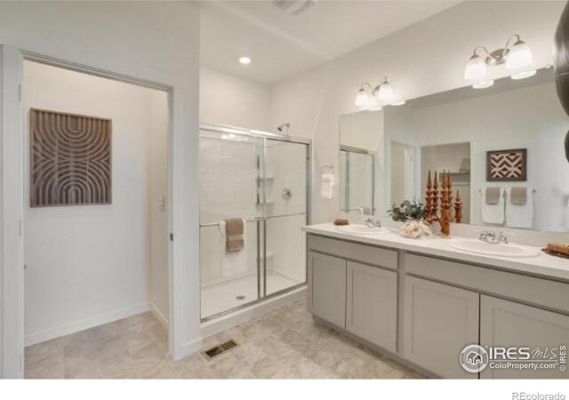1885 Mount Monroe Dr, Berthoud, CO 80513 - bathroom featuring double vanity and a shower stall