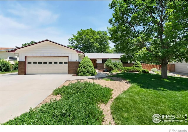 3310 Apple Ave, Loveland, CO 80538 - ranch-style home featuring concrete driveway, an attached garage, and brick siding