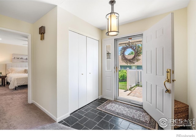 40 Walter Way, Broomfield, CO 80020 - entrance foyer with baseboards and dark carpet