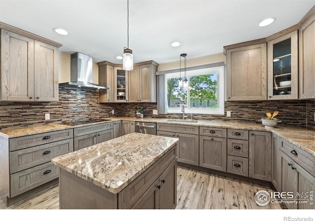 40 Walter Way, Broomfield, CO 80020 - kitchen featuring wall chimney exhaust hood, black stovetop, light wood finished floors, light stone countertops, and decorative backsplash