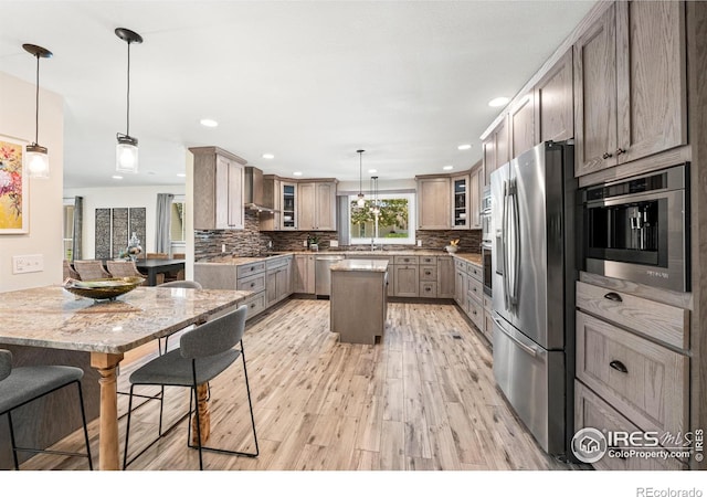 40 Walter Way, Broomfield, CO 80020 - kitchen with appliances with stainless steel finishes, a center island, light wood-style flooring, glass insert cabinets, and recessed lighting