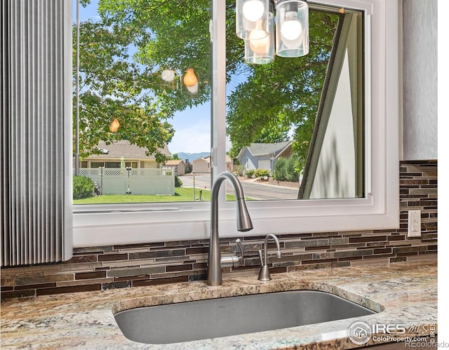 40 Walter Way, Broomfield, CO 80020 - kitchen view of backsplash, light stone counters, and a chandelier