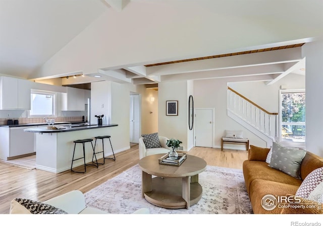 725 Union Ave, Boulder, CO 80304 - living room featuring beam ceiling, light wood-style floors, stairway, and high vaulted ceiling
