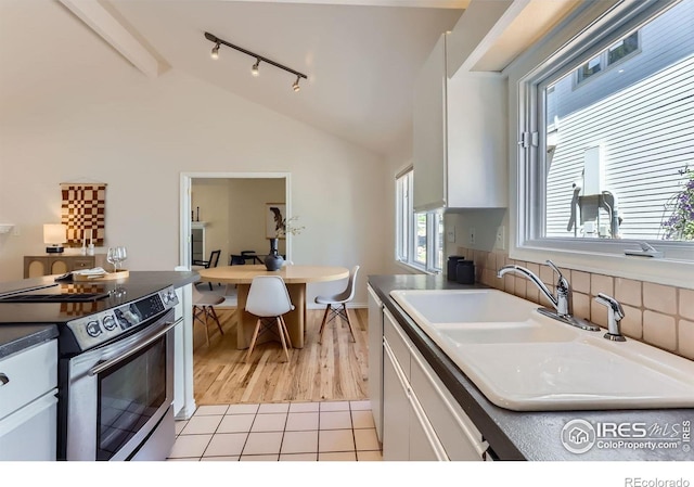 725 Union Ave, Boulder, CO 80304 - kitchen with stainless steel range with electric stovetop, lofted ceiling, white cabinets, track lighting, and light wood-style flooring