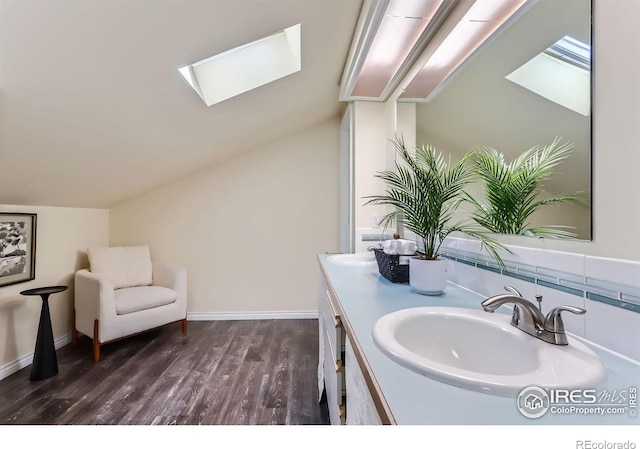 725 Union Ave, Boulder, CO 80304 - bathroom with a skylight, double vanity, lofted ceiling, and wood finished floors