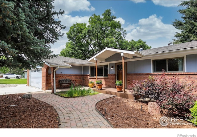 7459 Mount Meeker Rd, Longmont, CO 80503 - single story home with brick siding, concrete driveway, a garage, and roof with shingles