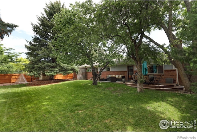 7459 Mount Meeker Rd, Longmont, CO 80503 - fenced backyard featuring an outdoor living space and a wooden deck