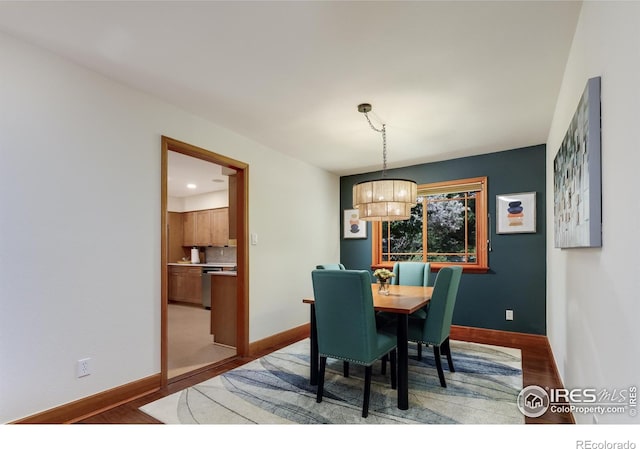 7459 Mount Meeker Rd, Longmont, CO 80503 - dining area with wood finished floors and a chandelier