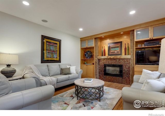 7459 Mount Meeker Rd, Longmont, CO 80503 - living area with wood finished floors, a brick fireplace, recessed lighting, and built in shelves