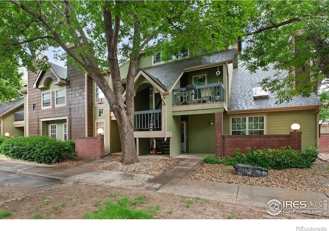 3565 Windmill Dr Unit F-7, Fort Collins, CO 80526 - view of front of home with a balcony, brick siding, stairs, and a shingled roof