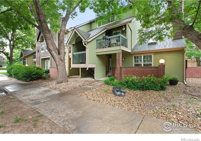 3565 Windmill Dr Unit F-7, Fort Collins, CO 80526 - view of front facade with a balcony, brick siding, and a shingled roof