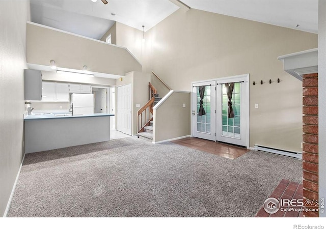 3565 Windmill Dr Unit F-7, Fort Collins, CO 80526 - unfurnished living room with a baseboard heating unit, carpet flooring, high vaulted ceiling, stairway, and a ceiling fan