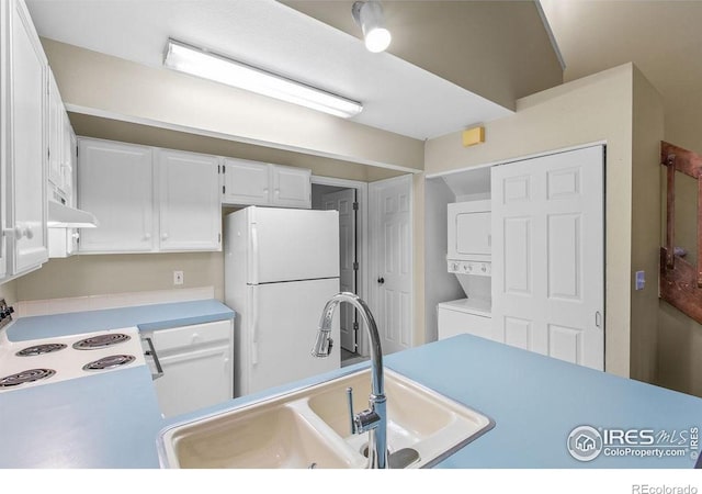 3565 Windmill Dr Unit F-7, Fort Collins, CO 80526 - kitchen featuring white appliances, stacked washer / dryer, white cabinets, and light countertops