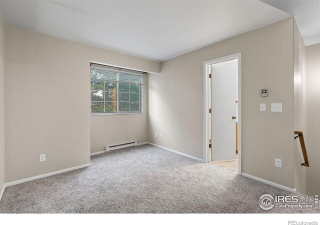 3565 Windmill Dr Unit F-7, Fort Collins, CO 80526 - carpeted empty room with a baseboard heating unit and baseboards